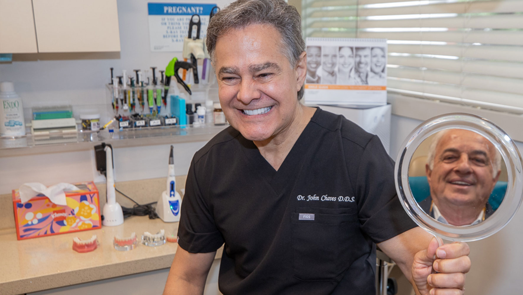 Doctor showing patient teeth after their dental procedure