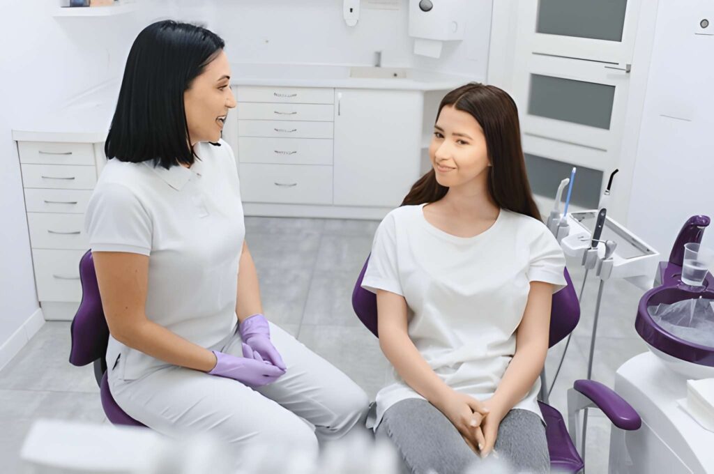 Dentist and patient discussing oral health in Woodland Hills, California dental office.