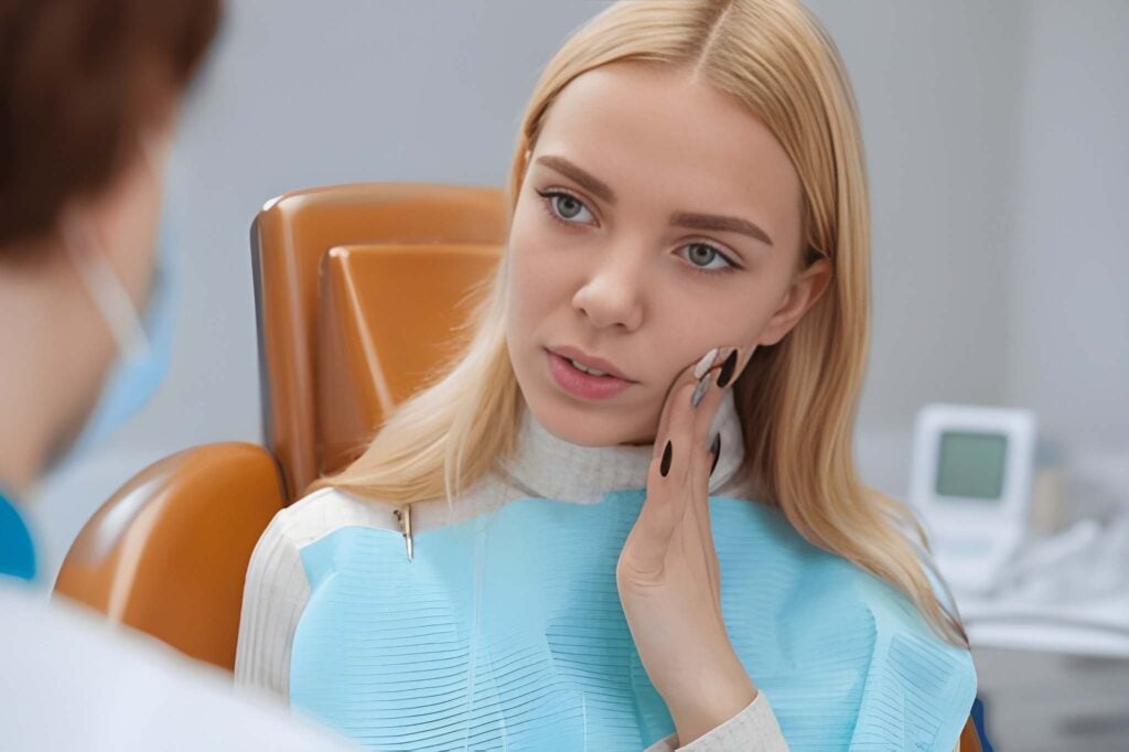 Woman experiencing tooth pain in dental chair, emergency dentistry in Woodland Hills, CA.