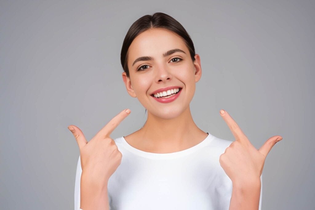 Woman smiling brightly showcasing whiter teeth after professional teeth whitening in Woodland Hills, California.