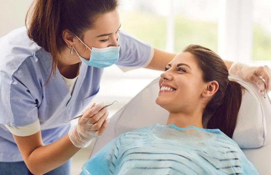 Dentist examining patient's smile in Woodland Hills, California