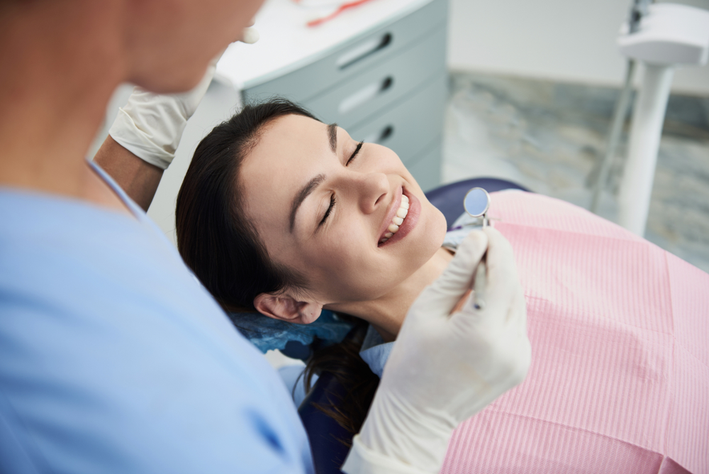 Relaxed patient receiving dental care near Greater Mulwood, Woodland Hills.